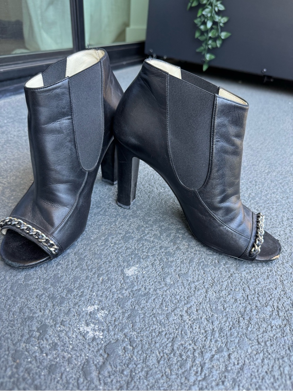 CHANEL Black Leather Open-Toe Heeled Booties with Chain Trim